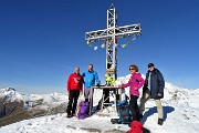49 Alla croce di vetta di Cima Grem (2049 m) con da sfondo l'Arera
